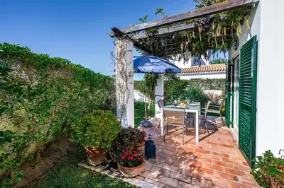 a patio of a house with a table and plants at Julieta by Algarve Villa Holidays in Galé