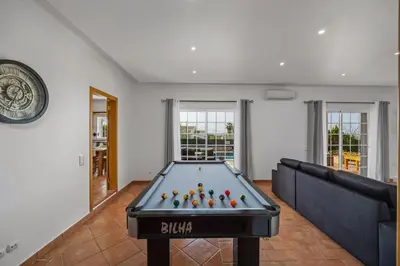 a pool table with balls in a living room at Laura by Algarve Villa Holidays in Albufeira