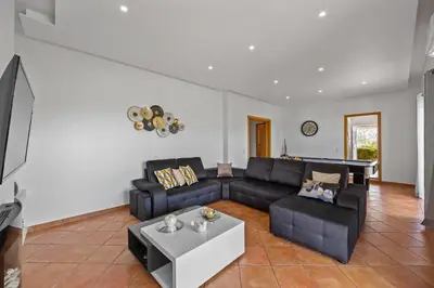 a living room with a couch and a table at Laura by Algarve Villa Holidays in Albufeira