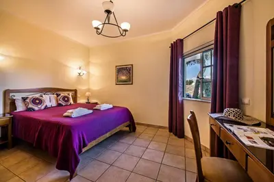 a bedroom with a bed and a window at Rebela by Algarve Villa Holidays in Galé