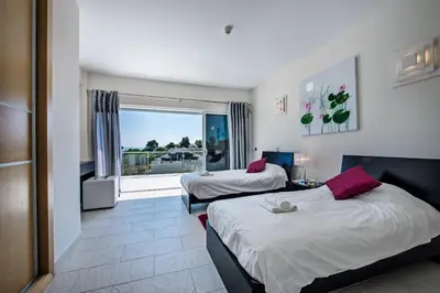 a hotel room with two beds and a window at Vista Mar by Algarve Villa Holidays in Sesmarias