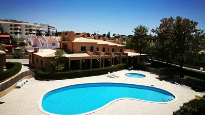 a large swimming pool in front of a house at Villa V2 C in Albufeira
