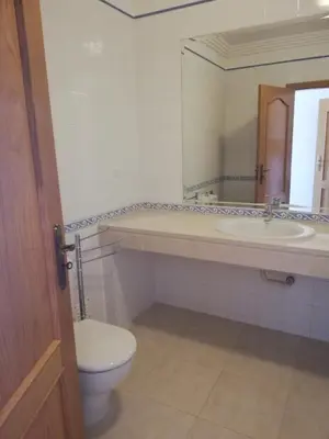 a bathroom with a toilet and a sink and a mirror at Villa V2 C in Albufeira