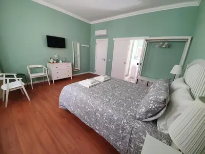 a bedroom with a bed and a television in it at Inn Faro - Casa Amarela - Guest House in Faro