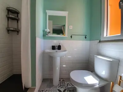 a bathroom with a white toilet and a sink at Inn Faro - Casa Amarela - Guest House in Faro