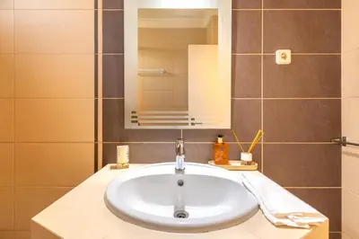a bathroom with a white sink and a mirror at Vila da Encosta - Private - Heated swimming pool - By bedzy in Albufeira