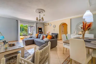 a living room with a couch and a table at Vila da Encosta - Private - Heated swimming pool - By bedzy in Albufeira