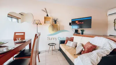 a living room with a couch and a table at Monte da Balaia Prime by Sunny Deluxe in Albufeira