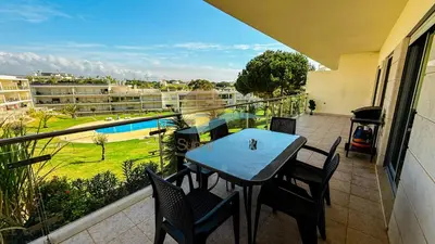 a balcony with a table and chairs and a pool at Monte da Balaia Prime by Sunny Deluxe in Albufeira