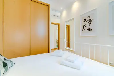 a bedroom with a bed with two towels on it at Casa Azul Traditional House - Faro in Faro