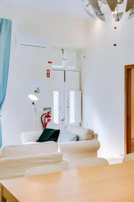 a living room with a white couch and a table at Casa Azul Traditional House - Faro in Faro