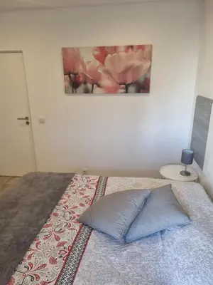 a bedroom with a bed with a picture on the wall at GA-DAL Stay Inn in Albufeira