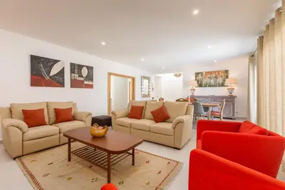 a living room with two couches and a table at Villa Alfazema - heatable pool in Albufeira