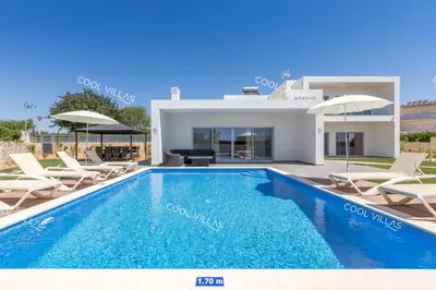 a villa with a swimming pool and a house at Villa Alfazema - heatable pool in Albufeira