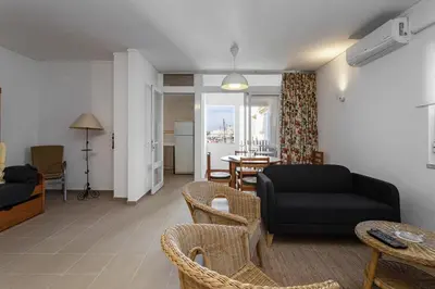 a living room with a couch and chairs and a table at Hopstays Vilamoura All In - Marina View Apartment in Vilamoura