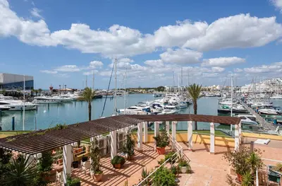 a view of a marina with boats in the water at Hopstays Vilamoura All In - Marina View Apartment in Vilamoura