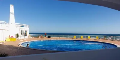 a swimming pool on a cruise ship with a lighthouse at Oura Ocean Front in Albufeira