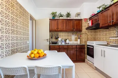 a kitchen with a table with a bowl of fruit on it at Sea View Fairy Tale in Faro