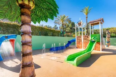 a water park with a water slide and a water fall at 3HB Guarana - All Inclusive in Albufeira