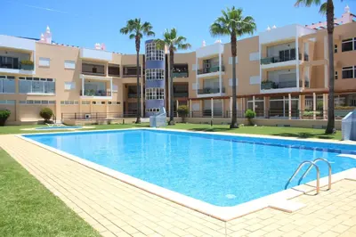 a swimming pool in front of a apartment building at Vilamoura, Marina Sol T1 in Quarteira