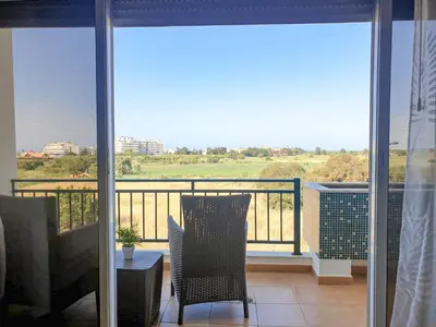 a balcony with a table and chairs and a view at Vilamoura, Marina Sol T1 in Quarteira