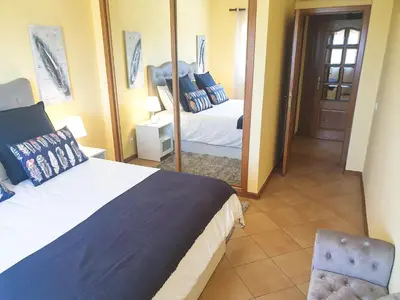 a bedroom with a bed and a large mirror at Vilamoura, Marina Sol T1 in Quarteira