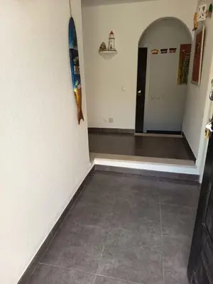 a hallway with a tile floor and a surfboard on the wall at Vilamoura Fantástica Moradia com Piscina Privada in Vilamoura