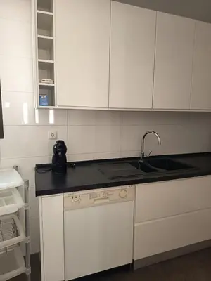 a kitchen with white cabinets and a sink at Vilamoura Fantástica Moradia com Piscina Privada in Vilamoura