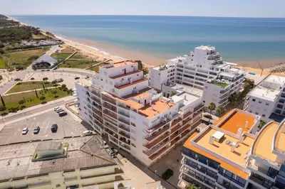 an aerial view of a city and the beach at Centralgarve - 1 Bedroom Apartment Near the Beach in Quarteira - Anglo Atlântico in Quarteira