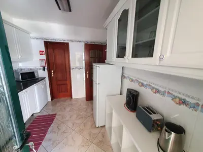 a kitchen with white cabinets and a white refrigerator at Algarve Villa Albufeira Altos dos Caliços in Albufeira
