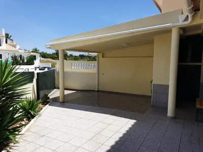 a garage with awning on the side of a house at Algarve Villa Albufeira Altos dos Caliços in Albufeira