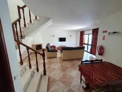 a living room with a staircase and a couch at Algarve Villa Albufeira Altos dos Caliços in Albufeira