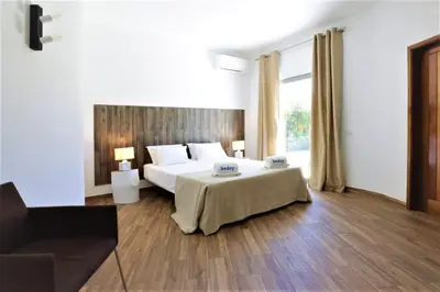 a bedroom with a bed and a large window at Villa Namora - Private Swimming pool & Hot Jacuzzi in Albufeira