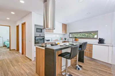 a kitchen with a island in the middle of a room at Villa Namora - Private Swimming pool & Hot Jacuzzi in Albufeira