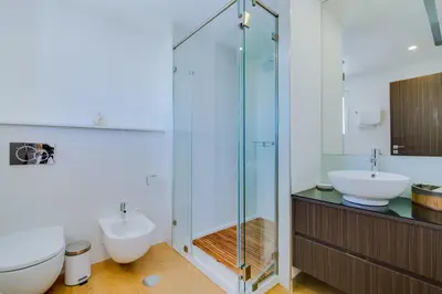 a bathroom with a shower and a toilet and a sink at Gold Suites - Luxurious apartment - Sea view in Vilamoura