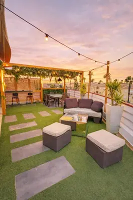 a patio with a couch and a table on the grass at Penthouse with Private Rooftop & Seaview in Guia