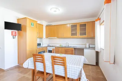 a kitchen with a table and chairs in a room at Recanto da Galé by Umbral in Albufeira