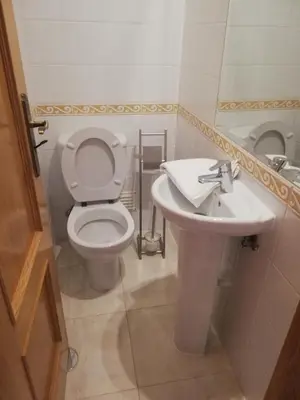 a bathroom with a toilet and a sink at Villa V2 Z in Olhos de Água
