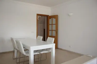 a white table and chairs in a room at Villa V2 Z in Olhos de Água