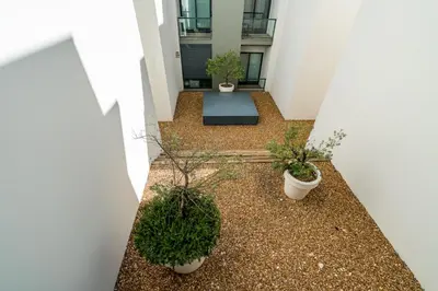 a hallway with potted plants in a building at BmyGuest - Cavalo Preto Beach Apartment in Loulé