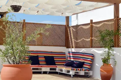 a patio with two benches under a canopy at Casa aOrta in Faro