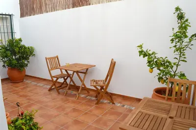 a table and chairs in a room with plants at Casa aOrta in Faro