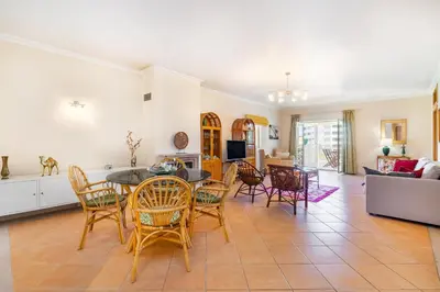 a living room with a table and chairs at WHome | Vilamoura Family Apartment in Quarteira