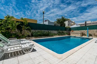 a swimming pool with two lounge chairs and a swimming pool at Villa Lageado by IntiHolidays in Albufeira