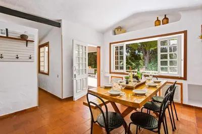 a kitchen with wooden cabinets and a white refrigerator at Villa Namibe na Quinta da Balaia in Albufeira