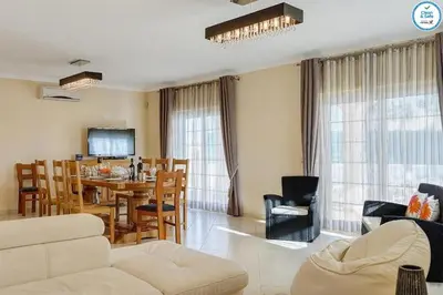 a living room with a table and a dining room at Villa Mikael - Free Wi-Fi - Aircon - Private Pool by bedzy in Albufeira