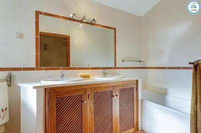 a bathroom with two sinks and a mirror and a tub at Villa Mikael - Free Wi-Fi - Aircon - Private Pool by bedzy in Albufeira