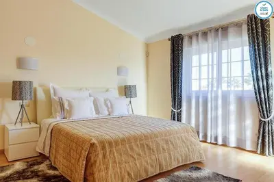 a bedroom with a bed and a large window at Villa Mikael - Free Wi-Fi - Aircon - Private Pool by bedzy in Albufeira