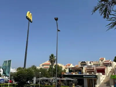 a tall street light in front of a building at Bellavista Modern Comfort, 3 Balcony, Family Apartment with Wi-Fi in Albufeira