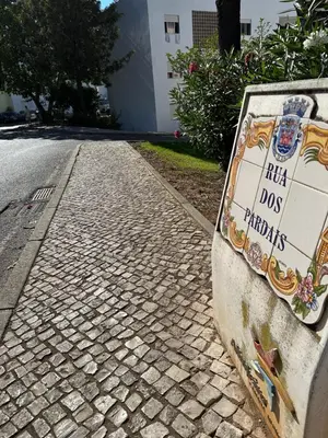 a sign on the side of a brick road at Bellavista Modern Comfort, 3 Balcony, Family Apartment with Wi-Fi in Albufeira